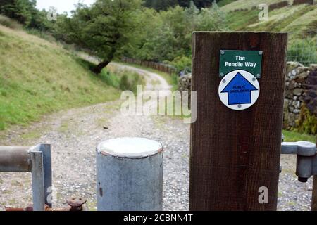 Sign for the Pendle Way Footpath on a Wooden Post by Upper Ogden Reservoir on the Way up Pendle Hill from Barley, Pendle, Lancashire, England, UK. Stock Photo