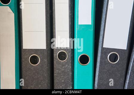 Colored folders for office files and paper on a shelf. Background image Stock Photo