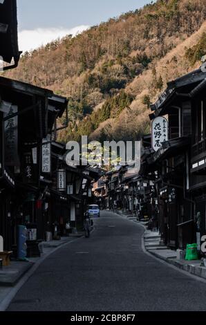 Old wooden house and narrow street of Narai-Juku the midpoint town on Nakasendo road, Edo period trading route between old Tokyo and Kyoto. Stock Photo