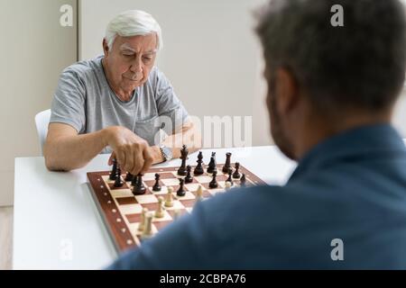Elderly Senior Playing Chess Table Board Game Stock Photo