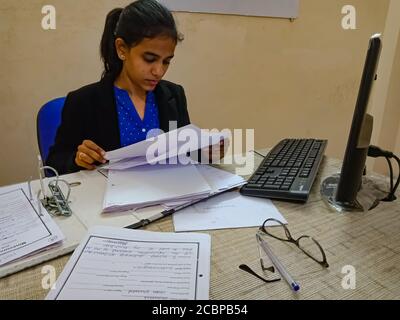 DISTRICT KATNI, INDIA - MARCH 18, 2020: An indian corporate human resource female manager working at office cabin. Stock Photo