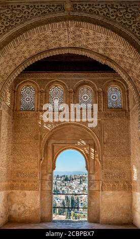 View of the Albayzin district through arched windows decorated with arabesques, Torre de Ismail, Palacio de Generalife, Granada, Andalusia, Spain Stock Photo