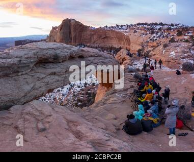 Arch Mesa Arch at sunrise, many photographers and tourists, Colorado River Canyon, at Grand View Point Trail, Island in the Sky, Canyonlands National Stock Photo