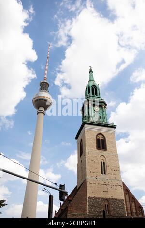 The towers of the Berlin Fernsehturm (TV tower) and St Mary's Church (Marienkirche) contrast the historic and the modern in Berlin, Germany. Stock Photo