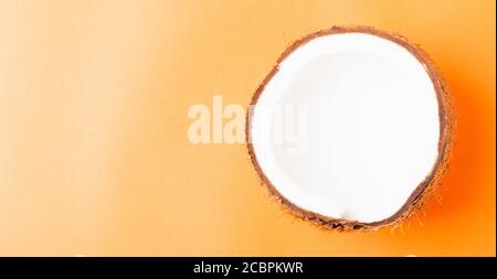Happy coconuts day concept, Fresh half coconut, studio shot isolated on orange background Stock Photo