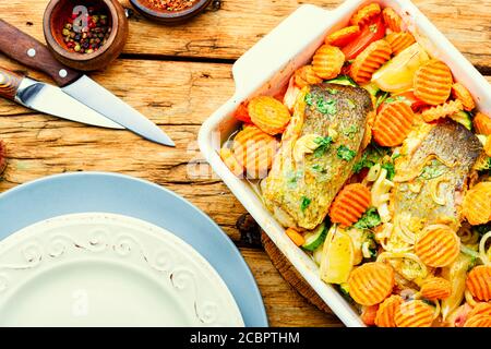 Baked fish steaks with grilled vegetables in baking dish.Delicious healthy grilled fish Stock Photo