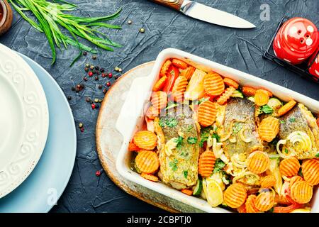 Baked fish steaks with grilled vegetables in baking dish.Delicious healthy grilled fish Stock Photo