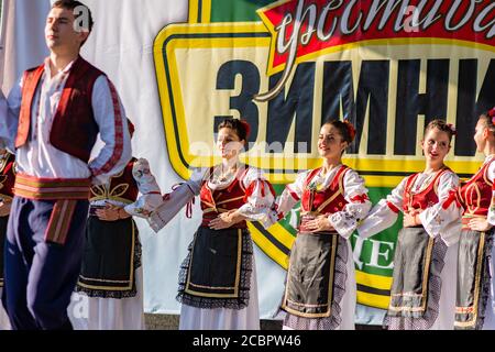 Koceljeva / Serbia - October 1, 2016: Young men and girls dancing Serbian traditional national folk dance Kolo Stock Photo