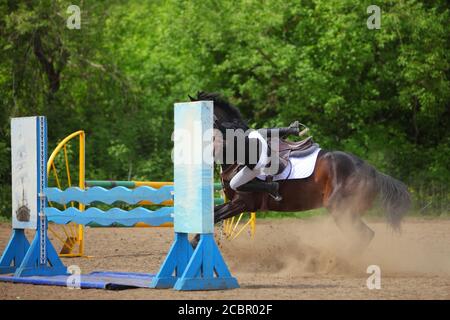 Horse rider falling off a horse Stock Photo