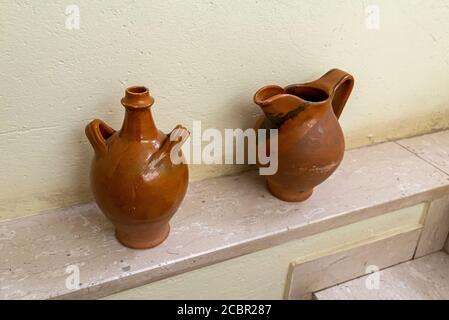 the ancient terracotta pot and wooden nestoli Stock Photo