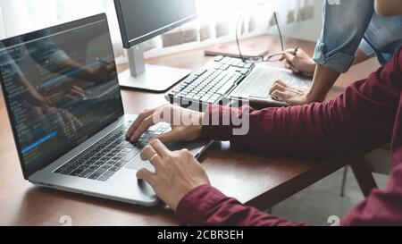 Team of Programmer working to find solution to problem and coding technologies in a software developing company office Stock Photo
