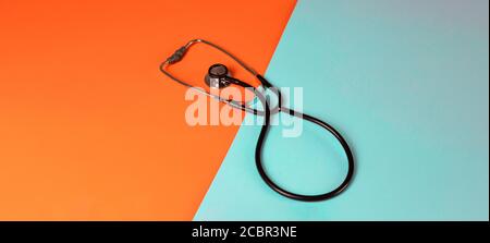 concept stethoscope on a bright bicolor background, panorama banner