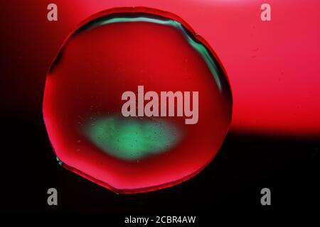 Macro shot of a liquid bubble on a dark red background - perfect for wallpapers Stock Photo