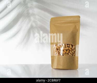 peanut snack on a blank standing pouch mockup with transparent window Stock Photo