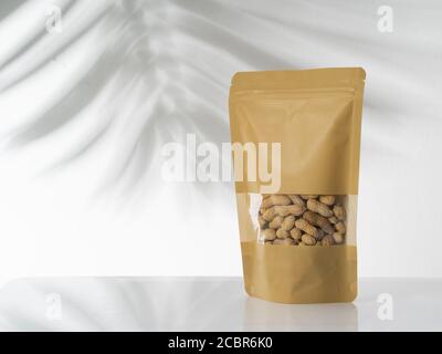 peanut snack on a blank standing pouch mockup with transparent window Stock Photo