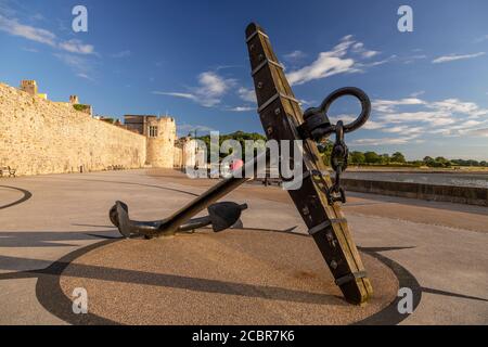 Anchor by Caernarfon town walls on the North Wales coast Stock Photo