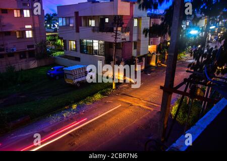 Light trail of moving vehicles with buildings around .Speed light trails showing us the image of an indian street Stock Photo