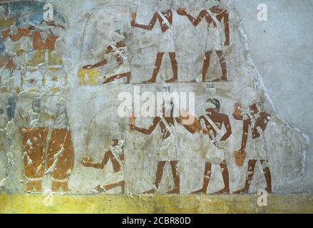 Wall painting depicts a bustling scene of artisans and workers preparation at the tomb of Rekhmire from the 18th Dynasty at the Theban Necropolis 'Tombs of the Nobles' complex opposite Luxor Egypt Stock Photo