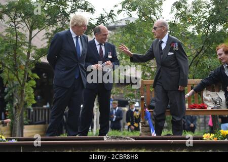 Prime Minister Boris Johnson (left) and Defence Secretary Ben Wallace (centre) during the national service of remembrance marking the 75th anniversary of VJ Day at the National Memorial Arboretum in Alrewas, Staffordshire. Stock Photo