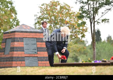 Prime Minister Boris Johnson lays a wreath at the Royal British Legion Service of Commemoration at the Sumatra Railway Memorial during the national service of remembrance marking the 75th anniversary of VJ Day at the National Memorial Arboretum in Alrewas, Staffordshire. Stock Photo