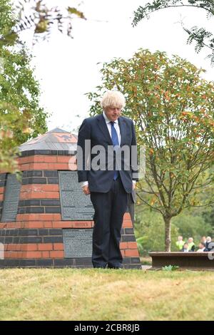 Prime Minister Boris Johnson lays a wreath at the Royal British Legion Service of Commemoration at the Sumatra Railway Memorial during the national service of remembrance marking the 75th anniversary of VJ Day at the National Memorial Arboretum in Alrewas, Staffordshire. Stock Photo