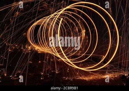 Spinning fireworks light making attractive design in the night