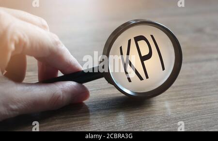 Magnifying glass searching KPI. Key performance indicator. Business concept Stock Photo