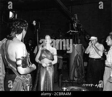 VICTOR MATURE HEDY LAMARR CECIL B. DeMILLE and Cinematographer GEORGE BARNES on set candid during filming of SAMSON AND DELILAH 1949 director CECIL B. DeMILLE Paramount Pictures Stock Photo