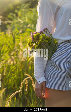 The concept of closeness to nature - flowers in the pocket  Stock Photo