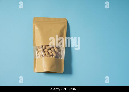 peanut snack on a blank standing pouch mockup with transparent window Stock Photo