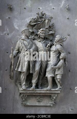 Soldiers as liberators and civilian family are celebrating liberation and victory in war and warfare. Statue made in style of socialist realism. Stock Photo