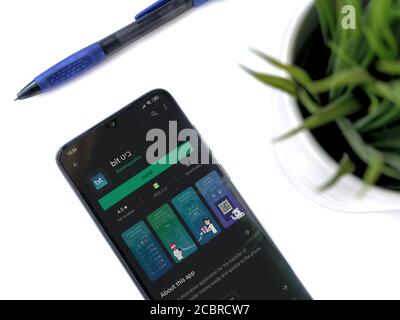 Lod, Israel - July 8, 2020: Modern minimalist office workspace with black mobile smartphone with Bit app play store page on a white background. Close Stock Photo