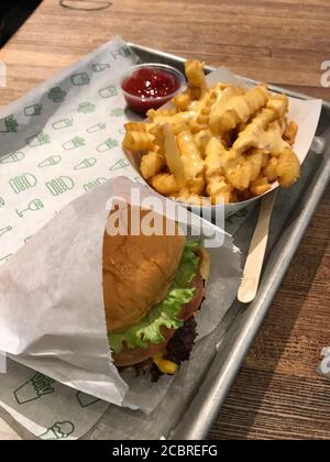 Shake Shack meal with burger, crinkle cut cheese fries and ketchup. Detroit, Michigan / USA