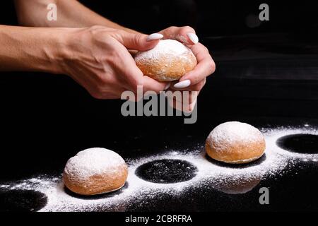 Homemade pastries. White buns are separated by hand. Photo of baking. Stock Photo