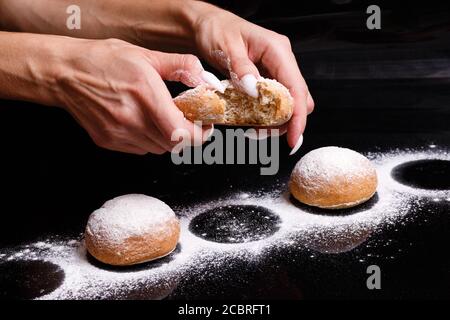 Homemade pastries. White buns are separated by hand. Photo of baking. Stock Photo