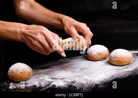 Homemade pastries. White buns are separated by hand. Photo of baking. Stock Photo