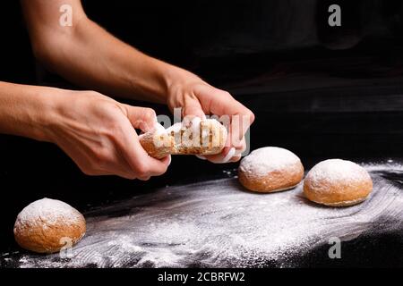 Homemade pastries. White buns are separated by hand. Photo of baking. Stock Photo