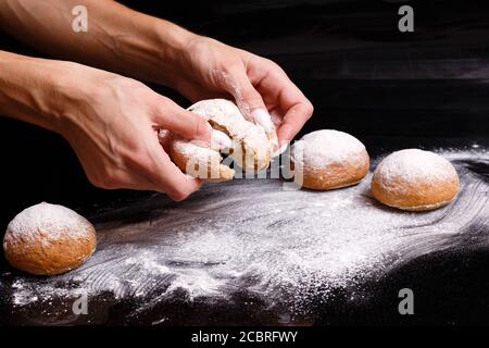 Homemade pastries. White buns are separated by hand. Photo of baking. Stock Photo
