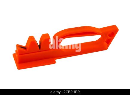 Red plastic knife sharpener isolated on white background. It is easy to sharpen a knife on it. Stock Photo