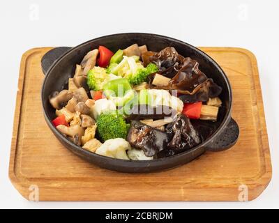 Vegetables on a hot frying pan (Peppers, black mushrooms, Chinese asparagus, broccoli, cauliflower, mushrooms, spices, onion oil, sesame oil)