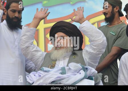 Khadim Hussain Rizvi leader of a religious group Tehreek-e-Labaik Pakistan (TLP) a hard line religious political party, addressing to supporters during a rally to mark Pakistan's Independence Day in Lahore. As the nation celebrate the 73rd Independence Day of Pakistan in befitting manners, Besides, vehicles could be seen on roads painted with national flag colors, which shows the enthusiasm of the people to commemorate the country's Independence Day.The annual celebration is every 14th day of August. The country gained its independence from the British rule on August 14, 1947. During the celeb Stock Photo