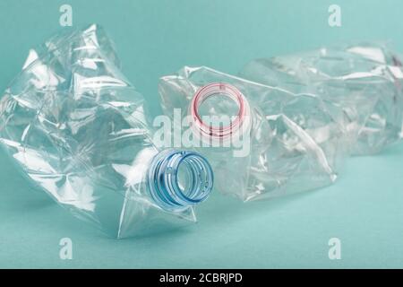 Used crushed plastic bottles on blue background. Stock Photo