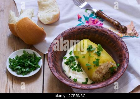 Stuffed peppers served with sour cream and bread, a traditional dish of different nations. Stock Photo