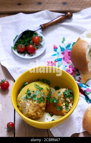 Stuffed peppers served with sour cream and bread, a traditional dish of different nations. Stock Photo