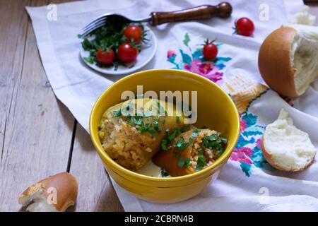 Stuffed peppers served with sour cream and bread, a traditional dish of different nations. Stock Photo