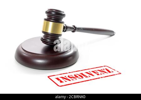 Judge gavel and a red stamp with the German word Insolvenz (meaning insolvency) isolated on a white background Stock Photo