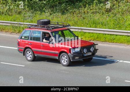 1999 90s nineties red Land Rover Range Rover P38 2.5TD DSEVehicular traffic moving vehicles, cars driving vehicle on UK roads, motors, motoring on the M6 motorway highway network. Stock Photo