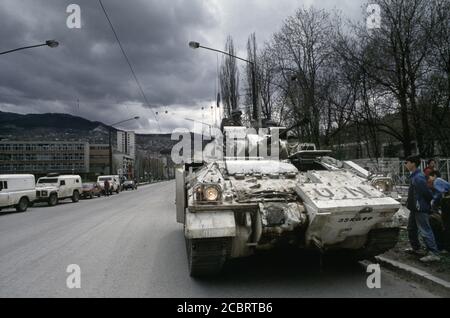 13th April 1994 During the Siege of Sarajevo: local boys take an interest in a British Army Warrior MCV on Alipašina Street. Stock Photo