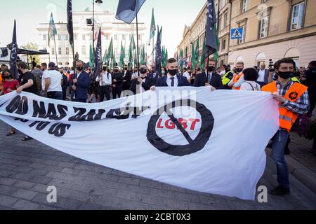 Warsaw, Pl. 15th Aug, 2020. Several hundred people are seen taking part in a march of the ultranaionatlist All Polish Youth (Mlodziez Wszechpolska) in Warsaw, Poland on August 15, 2020. The far-right and ultranationalist youth organisation organized a march on Saturday in light of the 100th anniversary of the Battle of Warsaw, the battle that turned the tide on the Bolshevik invasion of Europe. The All Polish Youth also oppose liberal values and oppose non-binary gender people who they see as a threat to Polish culture. (Photo by Jaap Arriens/Sipa USA) Credit: Sipa USA/Alamy Live News Stock Photo