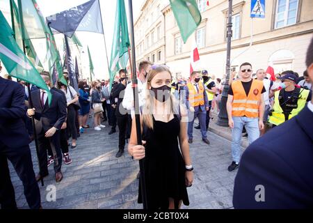 Warsaw, Pl. 15th Aug, 2020. Several hundred people are seen taking part in a march of the ultranaionatlist All Polish Youth (Mlodziez Wszechpolska) in Warsaw, Poland on August 15, 2020. The far-right and ultranationalist youth organisation organized a march on Saturday in light of the 100th anniversary of the Battle of Warsaw, the battle that turned the tide on the Bolshevik invasion of Europe. The All Polish Youth also oppose liberal values and oppose non-binary gender people who they see as a threat to Polish culture. (Photo by Jaap Arriens/Sipa USA) Credit: Sipa USA/Alamy Live News Stock Photo